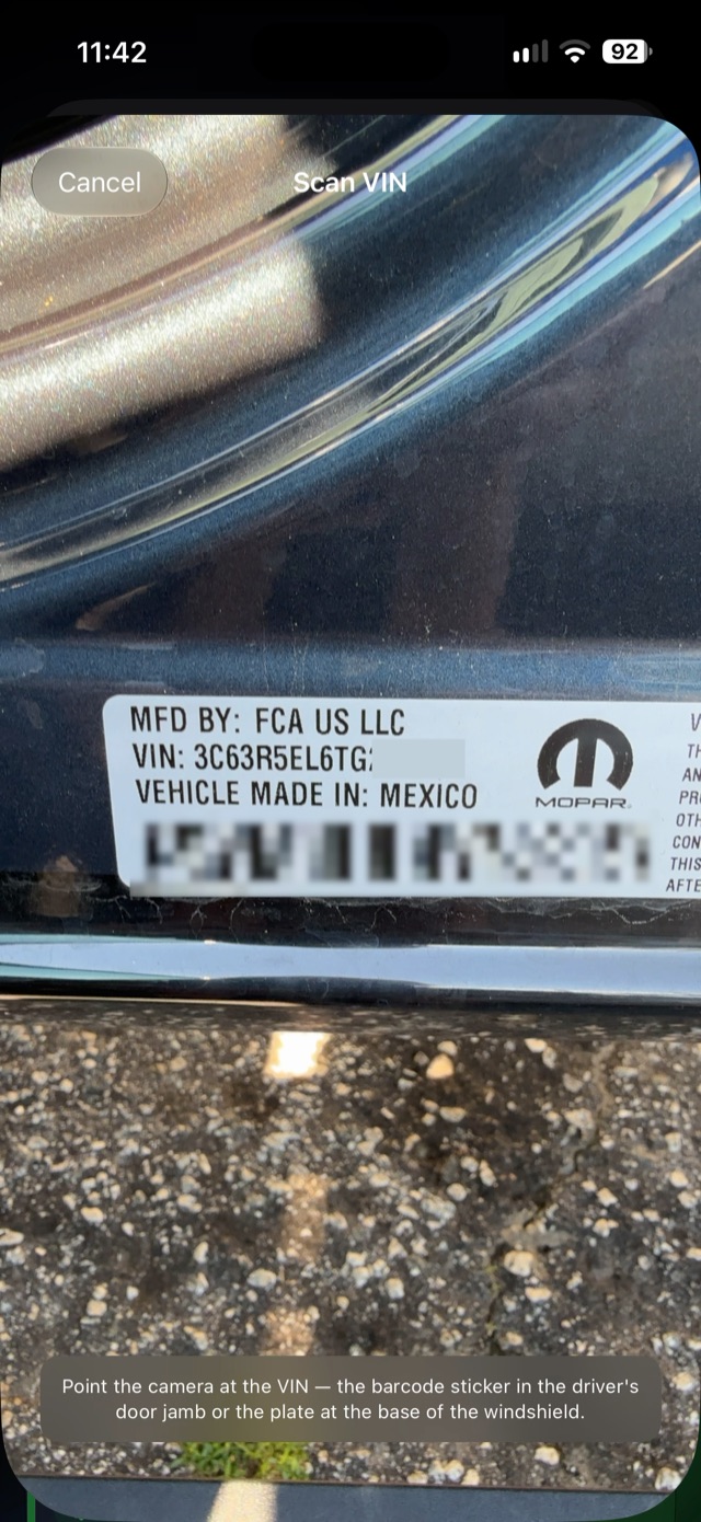 The VIN scanner pointed at the sticker in a truck's door jamb